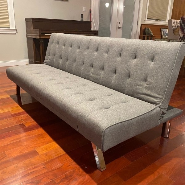 Image depicts a grey living room couch.